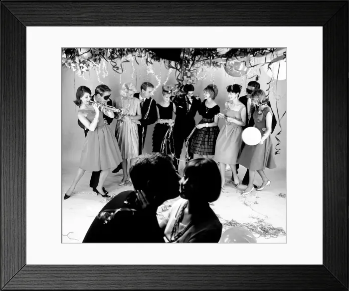 Framed Print : Couple kissing at a Christmas party. December 1961 Local Caption