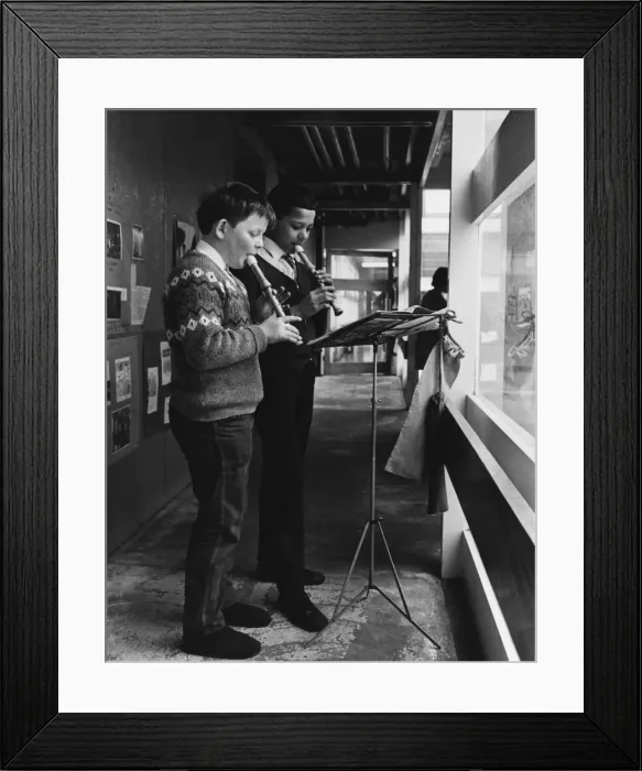 Framed Print : Two schoolboys playing the recorder during a music lesson at the Vittoria primary school