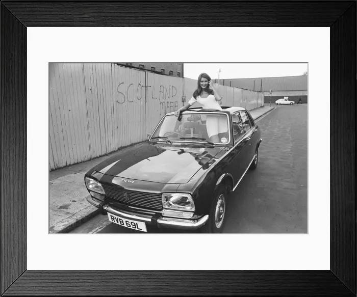 Framed Print : Reveille model Beulah Hughes seen here posing with a Peugeot 504 car which is a top prize Framed Print : Reveille model Beulah Hughes seen here posing with a Peugeot 504 car which is a top prize