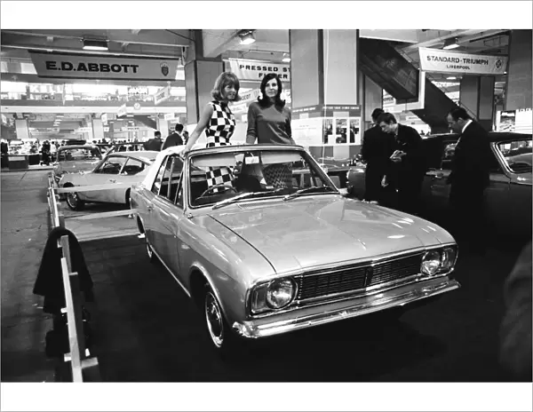 Models posing in this soft top Ford Cortina Mark 2 at the London Motor Show 18th October