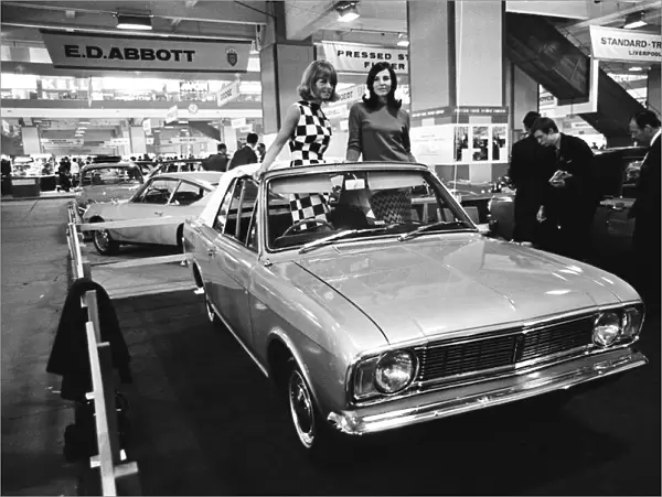 Models posing in this soft top Ford Cortina Mark 2 at the London Motor Show 18th October