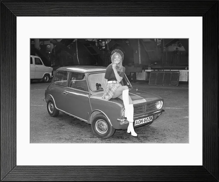 Framed Print : Reveille model seen here posing with a Mini Clubman car which is a top prize in Framed Print : Reveille model seen here posing with a Mini Clubman car which is a top prize in
