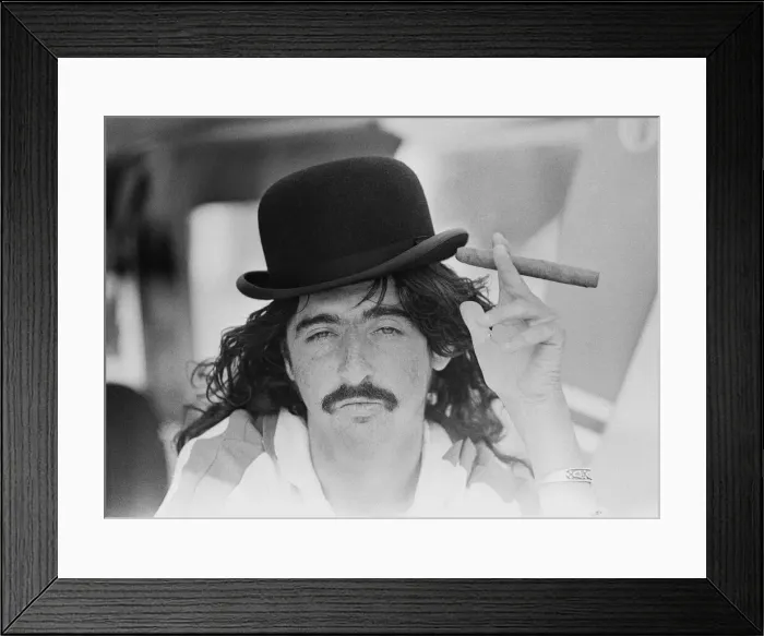 Framed Print : American rock singer Alice Cooper wearing a bowler hat and smoking a cigar during his Framed Print : American rock singer Alice Cooper wearing a bowler hat and smoking a cigar during his