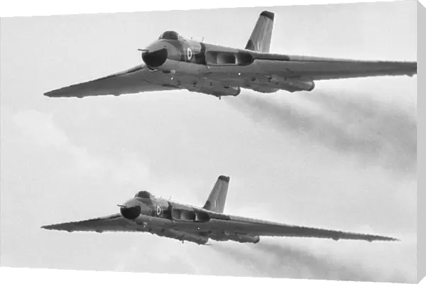 A pair of Avro Vulcan bombers seen here taking part in the fly past at RAF Scampton