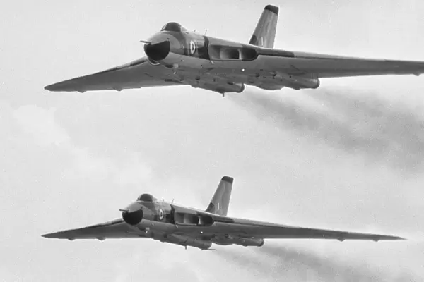 A pair of Avro Vulcan bombers seen here taking part in the fly past at RAF Scampton