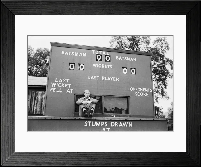 Framed Print : England footballer Bobby Charlton sidts in front of a cricket scoreboard at the team Framed Print : England footballer Bobby Charlton sidts in front of a cricket scoreboard at the team