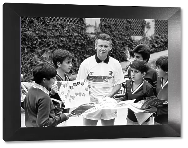 England footballer Peter Reid signs autographs for local children at the team base in