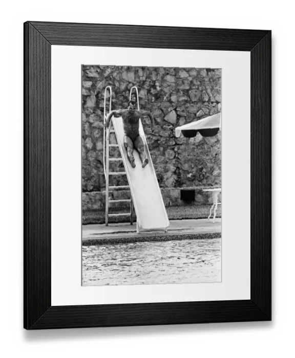 Framed Print : England footballer Ray Wilkins slides into the swimming pool at the Cima Club in