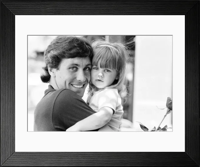 Framed Print : England footballer Kenny Sansom with his young daughter at the team base during the 1982
