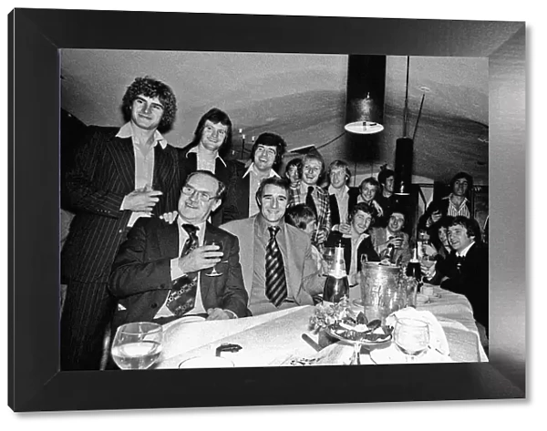 Manager Malcolm Allison with his Crystal Palace team relaxing in a bar drinking champagne