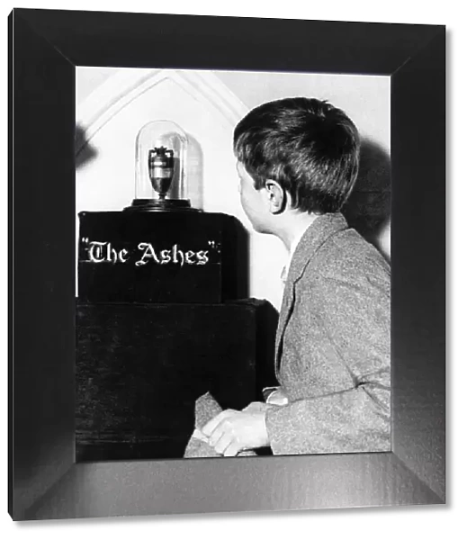 The Ashes Trophy, a young schoolboy looks