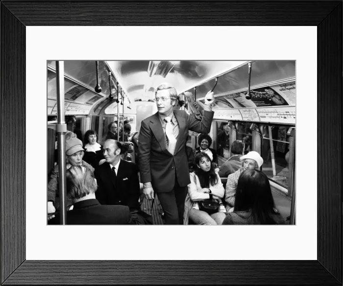 Framed Print : Actor Michael Caine travelling on the underground train at Aldwych tube station during Framed Print : Actor Michael Caine travelling on the underground train at Aldwych tube station during
