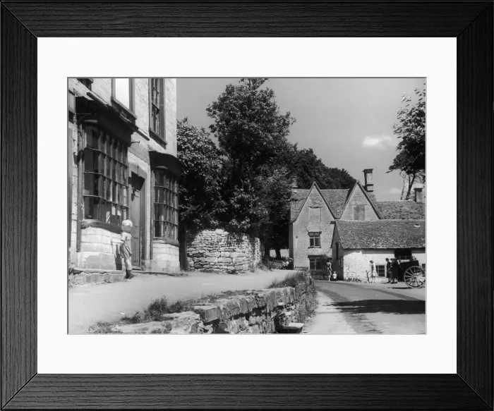 Framed Print : Young boy peering theough a shop window in the Cotswold village of Uley near Dursley in Framed Print : Young boy peering theough a shop window in the Cotswold village of Uley near Dursley in