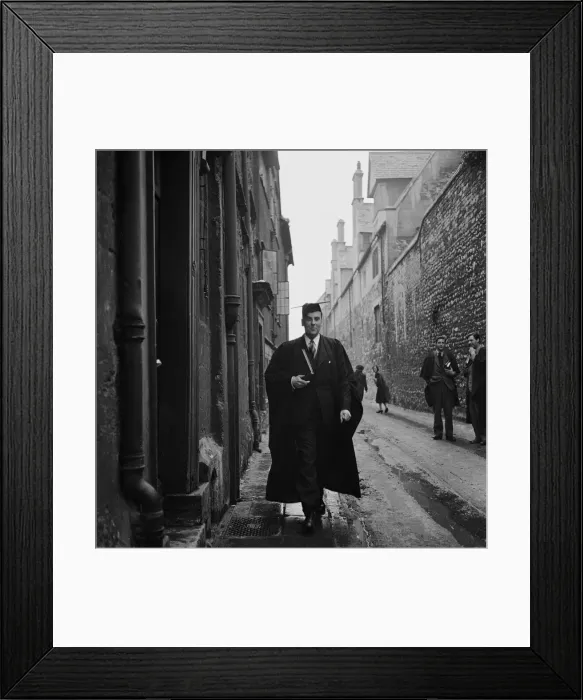 Framed Print : A student of Oxford University walks through one of the narrow back streets of the town Framed Print : A student of Oxford University walks through one of the narrow back streets of the town