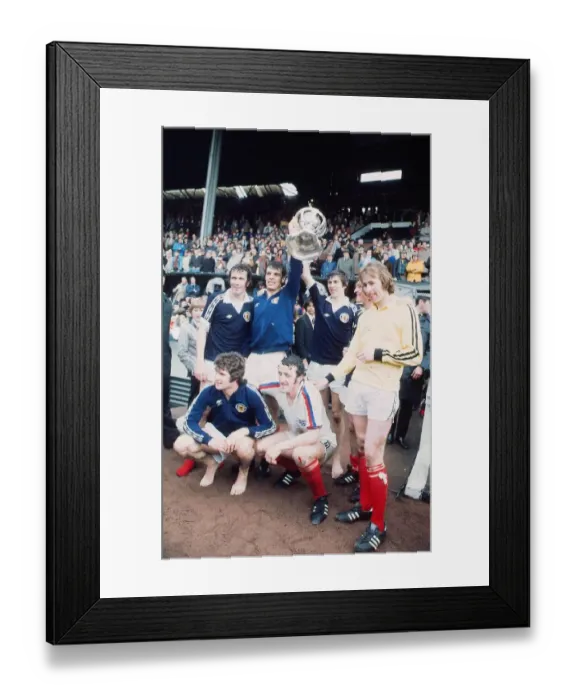 Framed Print : Scotland footballer Joe Jordan holds aloft the British International Football trophy with