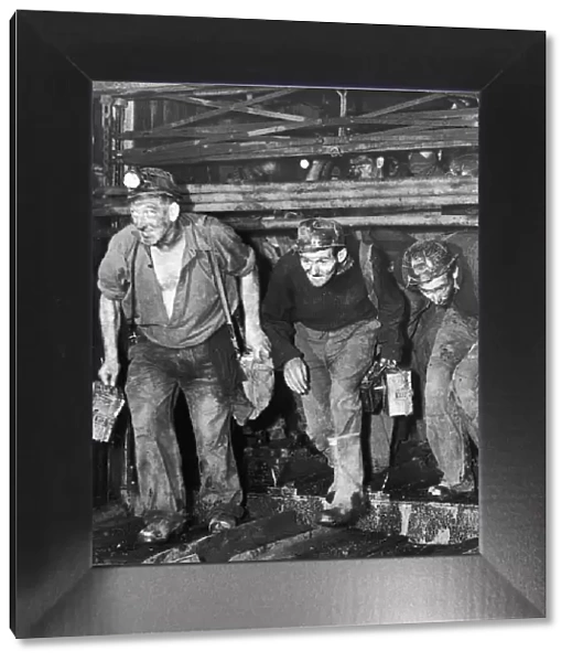 Miners coming off shift at the end of a hard day at the coal face. Circa 1960s