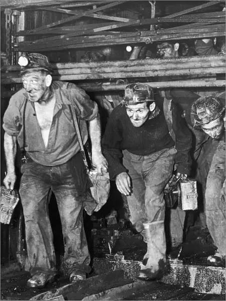 Miners coming off shift at the end of a hard day at the coal face. Circa 1960s