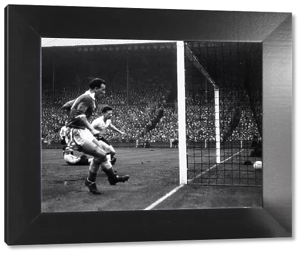 John Charles of Wales left scores against England in the international match between