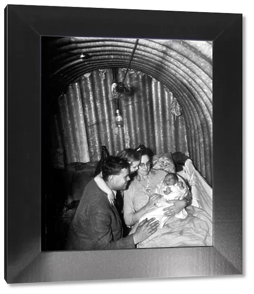 WW2 A family seeks refuge inside an Anderson Air Raid shelter during the blitz