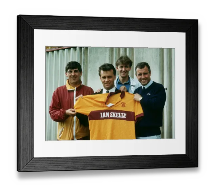 Framed Print : New Motherwell signing Davie Cooper poses with the team shirt as he stand with management