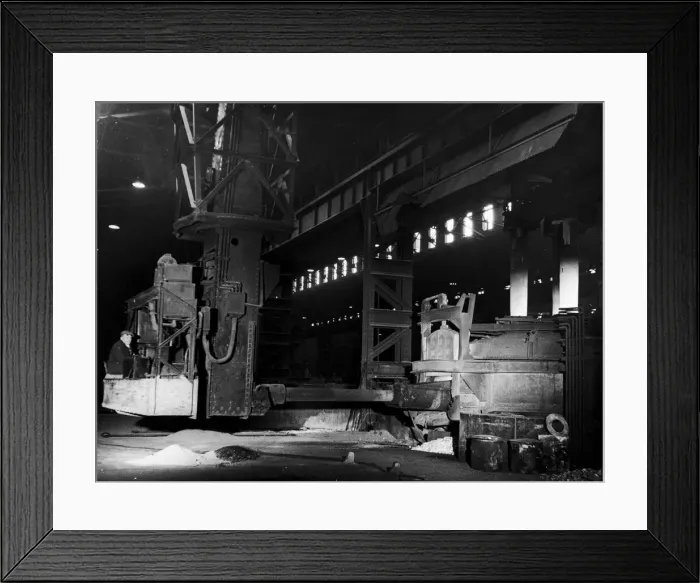 Framed Print : A mechanical charging machine feeding a 30 ton electric arc furnace at the English Steel Framed Print : A mechanical charging machine feeding a 30 ton electric arc furnace at the English Steel