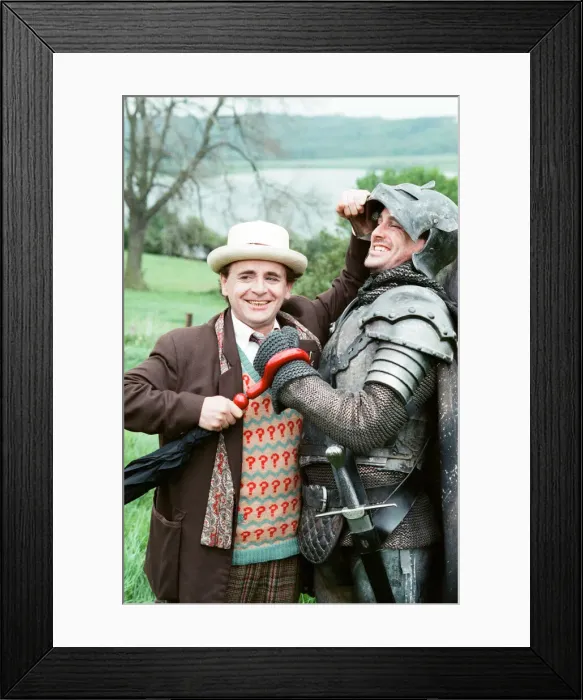 Framed Print : Christopher Bowen as Mordred crosses swords with Sylvester McCoy as the Doctor whilst Framed Print : Christopher Bowen as Mordred crosses swords with Sylvester McCoy as the Doctor whilst