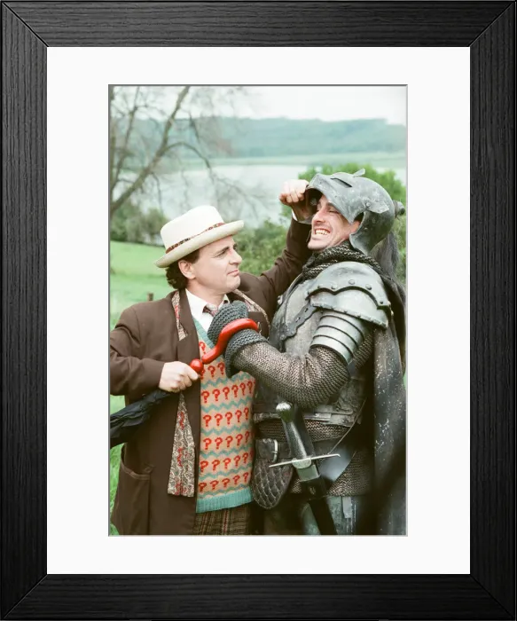 Framed Print : Christopher Bowen as Mordred crosses swords with Sylvester McCoy as the Doctor whilst Framed Print : Christopher Bowen as Mordred crosses swords with Sylvester McCoy as the Doctor whilst