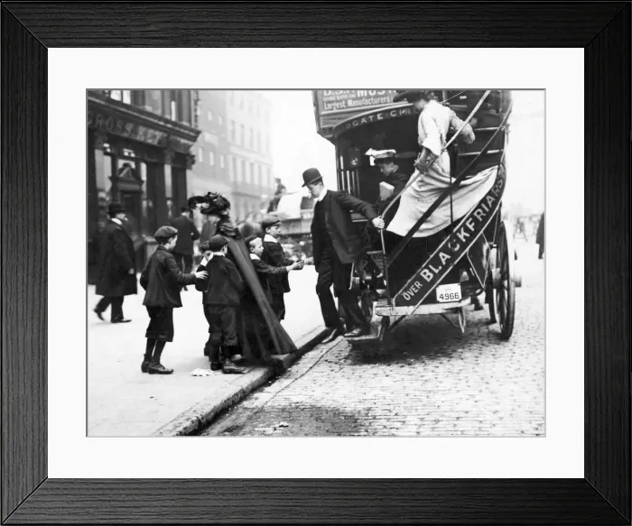 Framed Print : A group of children ask a male bus passenger for hisused ticket as he descends from Framed Print : A group of children ask a male bus passenger for hisused ticket as he descends from