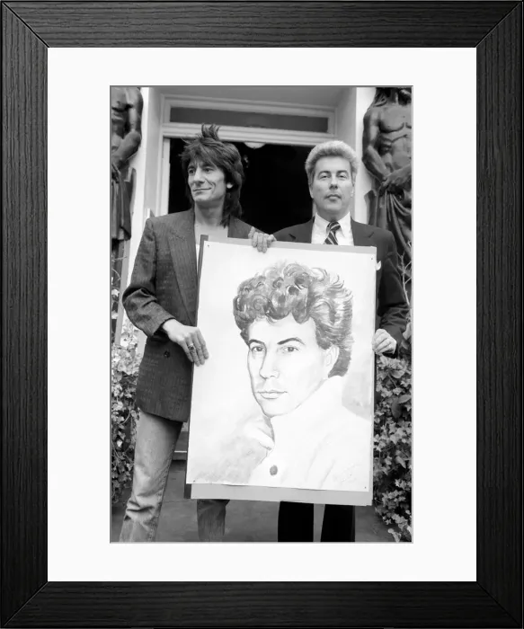 Framed Print : Rolling Stones: Ronnie Wood holds a painting of author Ken Follett who stands next to him Framed Print : Rolling Stones: Ronnie Wood holds a painting of author Ken Follett who stands next to him