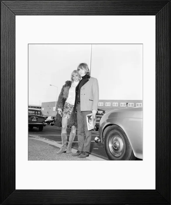 Framed Print : Brian Jones of the Rolling Stones melt his girl friend Anita Pallenberg as she arrived Framed Print : Brian Jones of the Rolling Stones melt his girl friend Anita Pallenberg as she arrived