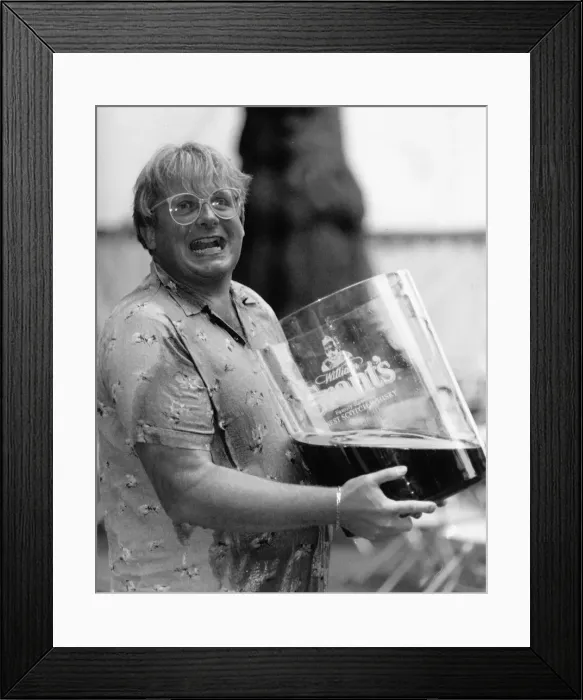 Framed Print : Christopher Biggins with giant glass of Grants Whiskey 1989
