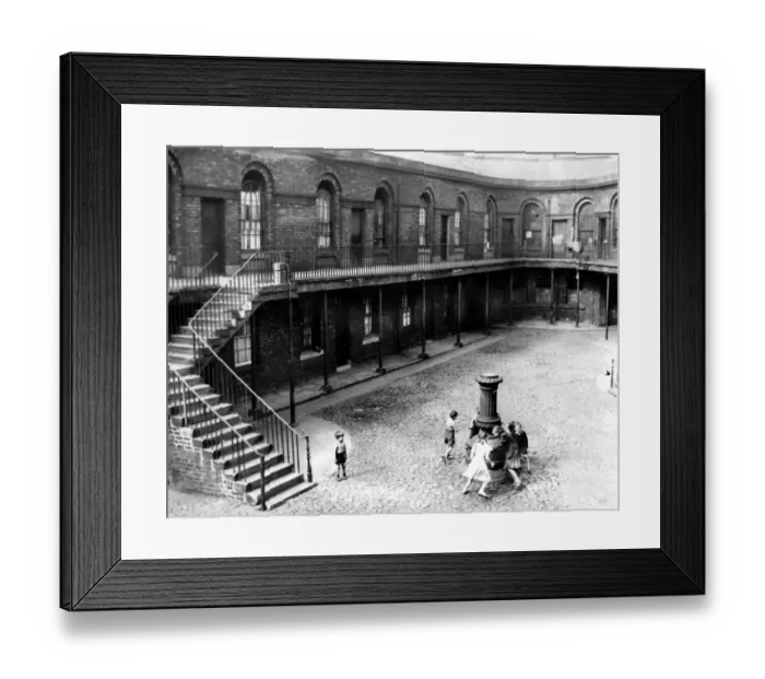 Framed Print : In the cobbled courtyard children play round the old lamp standard in Victoria Market