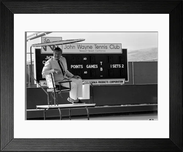 Framed Print : John Wayne who stars in Brannigan. Seen here at his tennis club