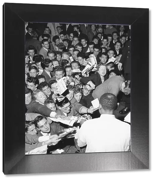 Fans rush forward to get the autograph of jazz legend Lionel Hampton at the Empress Hall