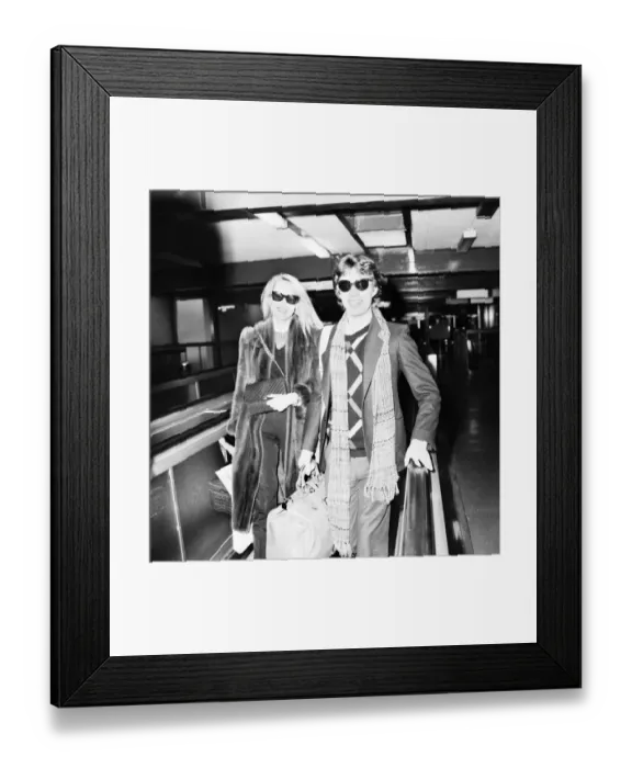 Framed Print : Rolling Stones. Mick Jagger and Jerry Hall leaving London Airport Heathrow for a