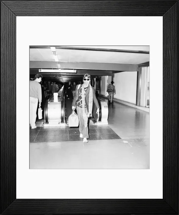 Framed Print : Rolling Stones. Mick Jagger leaving London Airport Heathrow for a Christmas Holiday in Framed Print : Rolling Stones. Mick Jagger leaving London Airport Heathrow for a Christmas Holiday in