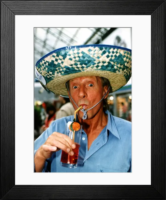 Framed Print : Denis Law enjoying a refreshing drink, wearing a sombrero. 12th August 1994 Framed Print : Denis Law enjoying a refreshing drink, wearing a sombrero. 12th August 1994