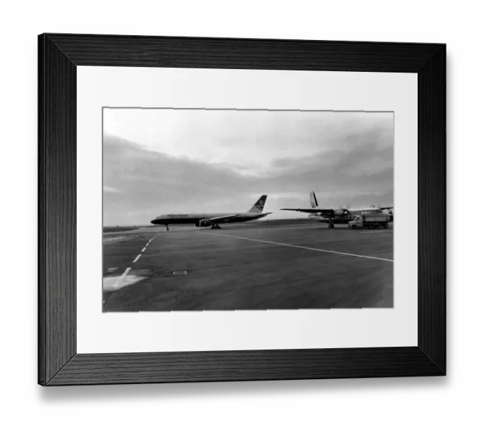 Framed Print : A British Airways 757 taxis past an Air UK Fokker F27 at Heathrow Airport