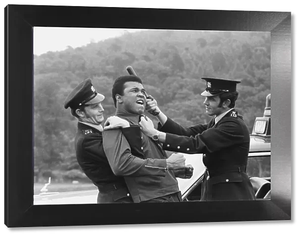 Muhammad Ali seen here playing a round with two policemen just outside Dublin