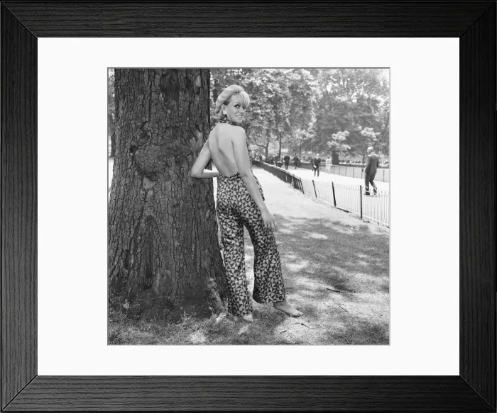 Framed Print : Ann Nightingale aged 25 blonde and barefoot seen here wearing a cat suit in navy
