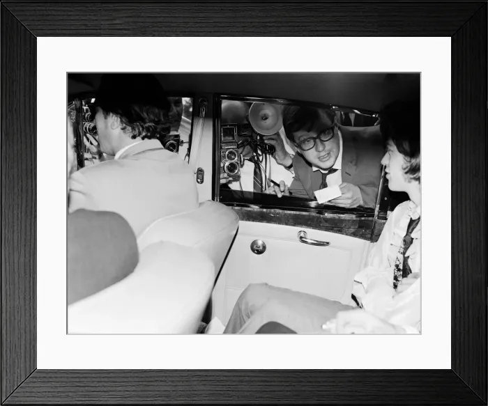 Framed Print : Mick Jagger of The Rolling Stones is besieged by reporters after leaving court in