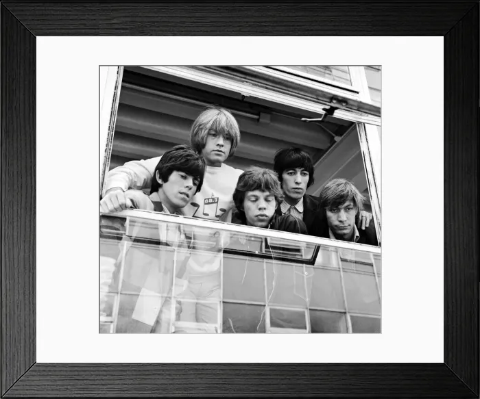 Framed Print : The Rolling Stones looking out of a window at female fans after being in make up before Framed Print : The Rolling Stones looking out of a window at female fans after being in make up before