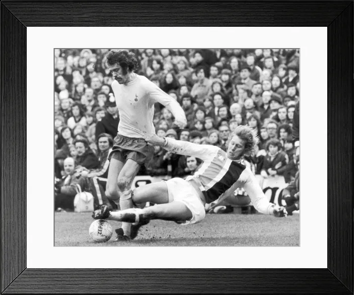 Framed Print : Mike England of Spurs is challenged for the ball by Bobby Bell of Crystal Palace during Framed Print : Mike England of Spurs is challenged for the ball by Bobby Bell of Crystal Palace during
