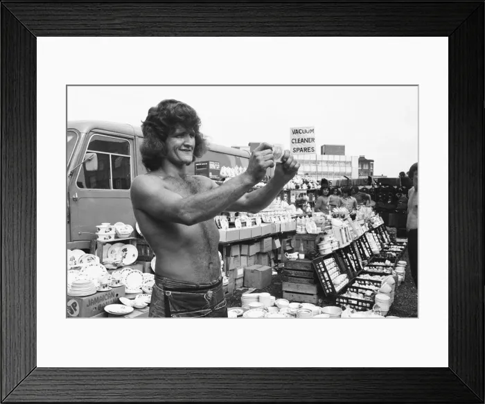 Framed Print : Bare chested Alan Dobbs who runs a pottery stall in London