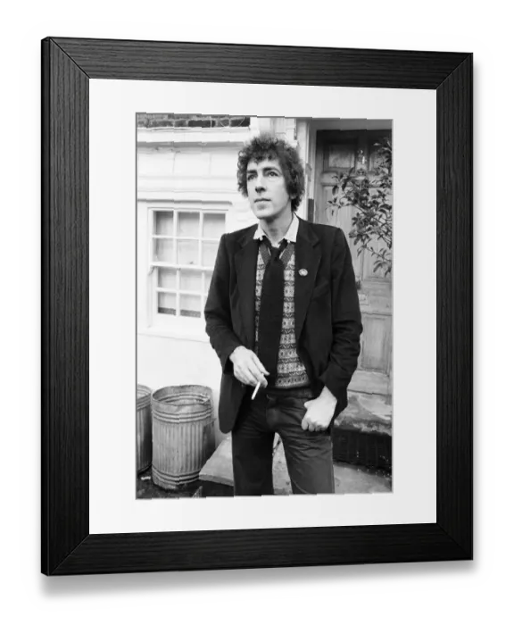 Framed Print : Comedian and actor Peter Cook smoking a cigarette. 25th March 1979