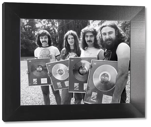 Heavy Metal group Black Sabbath pictured with the silver discs they received for