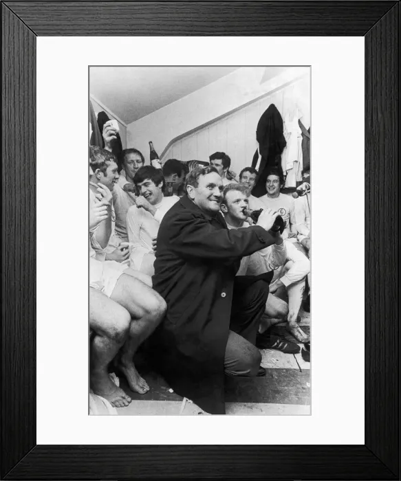 Framed Print : Leeds United manager Don Revie holds a bottle of champagne for captain Billy Bremner Framed Print : Leeds United manager Don Revie holds a bottle of champagne for captain Billy Bremner