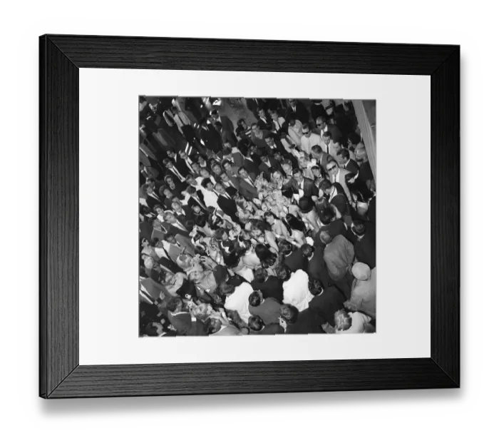 Framed Print : Hugh Hefner Boss of the Playboy Empire arrives with an entourage of Bunny Girls at London