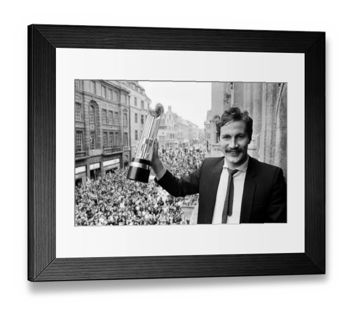 Framed Print : Oxford United footballer holds aloft the Second Division Championship trophy on an open Framed Print : Oxford United footballer holds aloft the Second Division Championship trophy on an open
