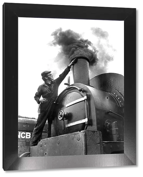 An Engineer giving his steam locomotive a last clean before going on show to the public